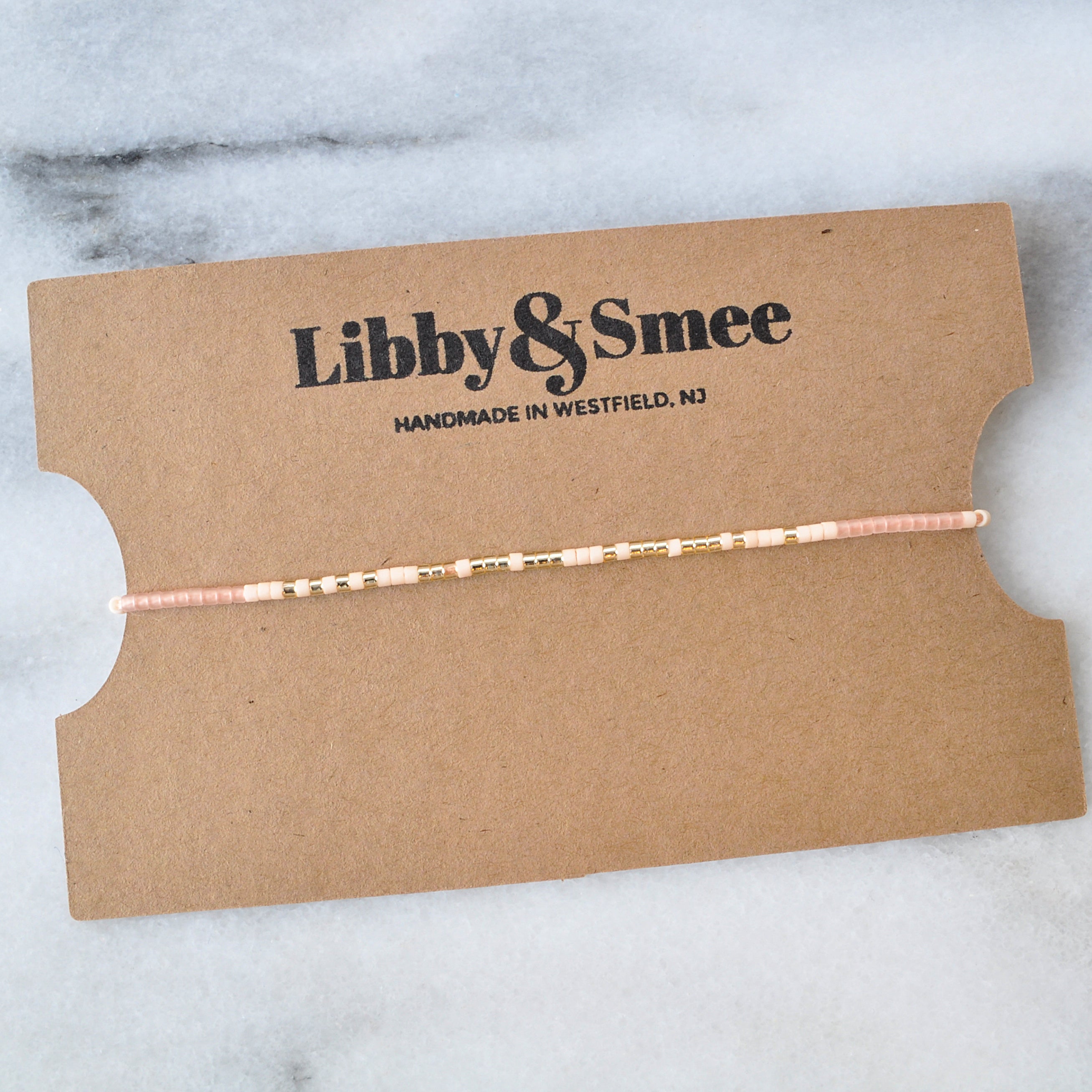 Hope Morse Code String Bracelet on a kraft bracelet display card with the logo Libby & Smee, handmade in Westfield, NJ