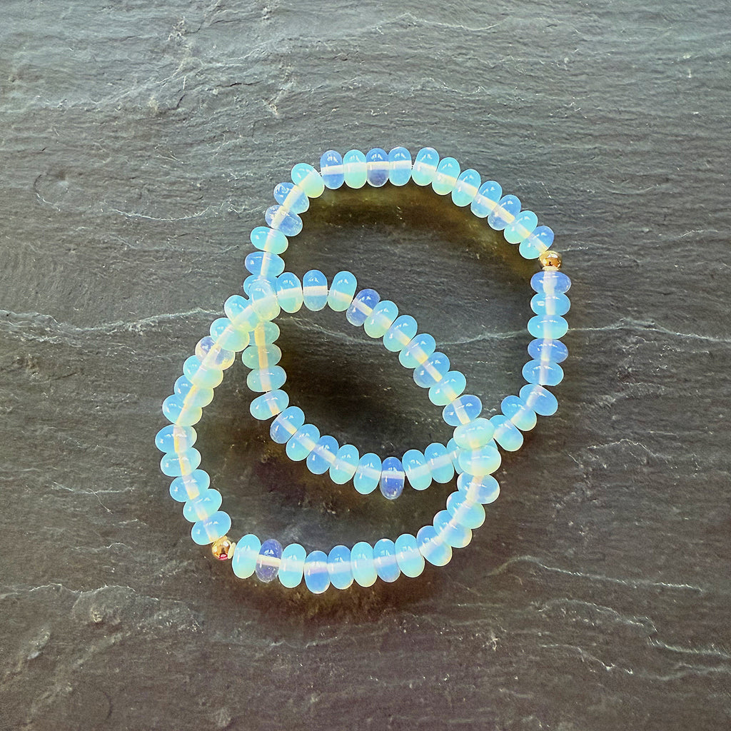 Opalite beaded bracelet on a dark stone surface