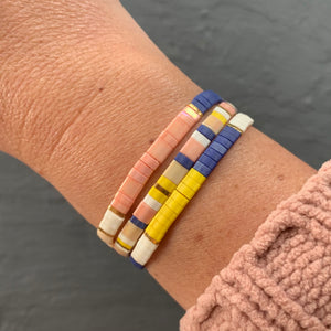 Classic Set of Libby & Smee stretch tile bracelets includes Yellow Colorblock in navy, ivory and yellow, Classic Colorblock in navy, ivory, blush and beige and The Classic, a mix of navy, ivory, beige, blush , yellow and gold. The three bracelets combine make up this tile bracelet curated set. 