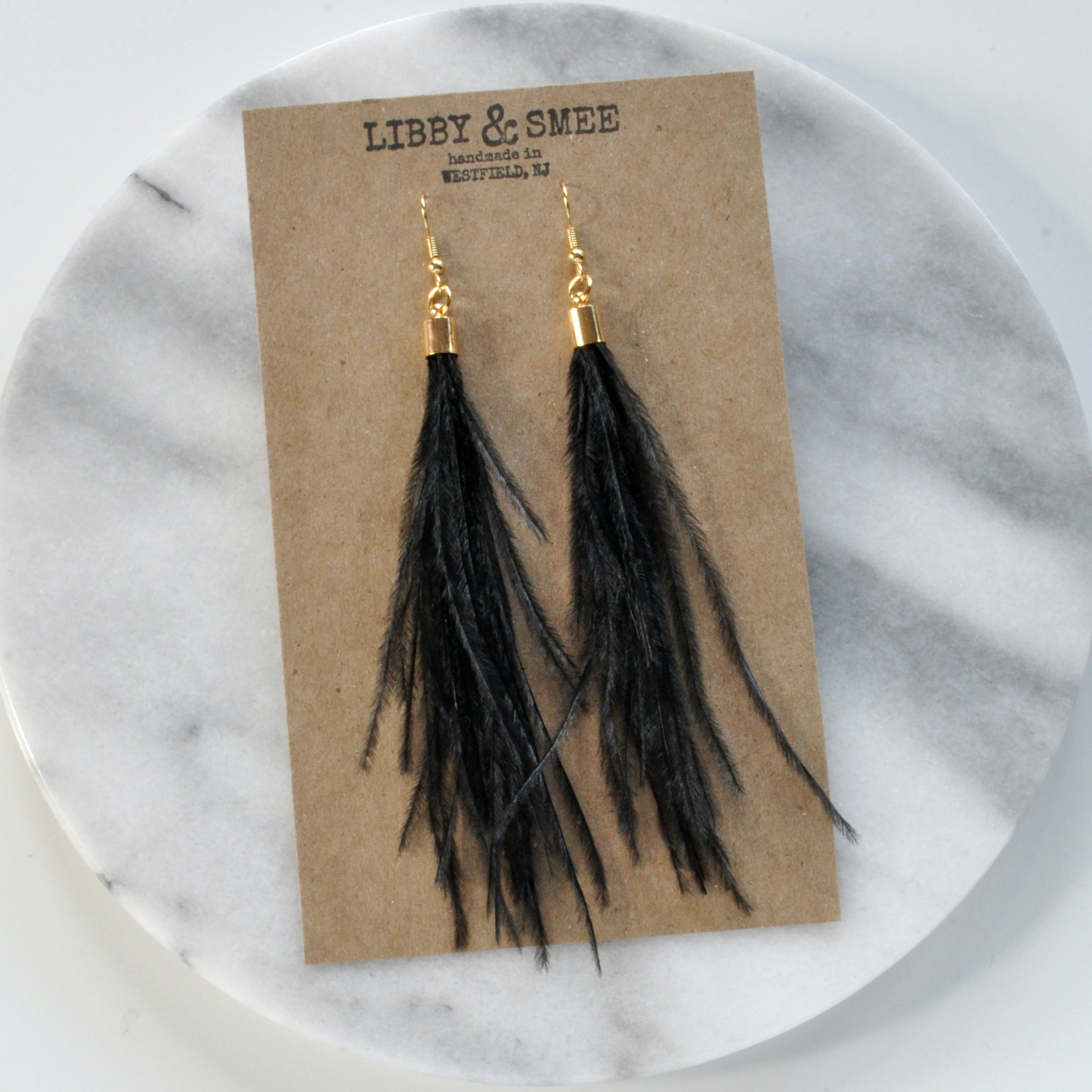 Libby & Smee Black Feather Earrings with Gold Caps, Still Life on Kraft Earring Card