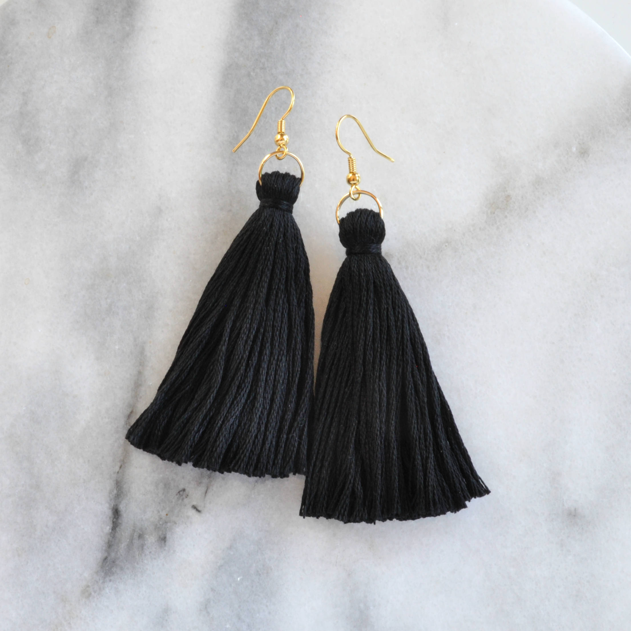 Libby & Smee black tassel earrings in long, still life 