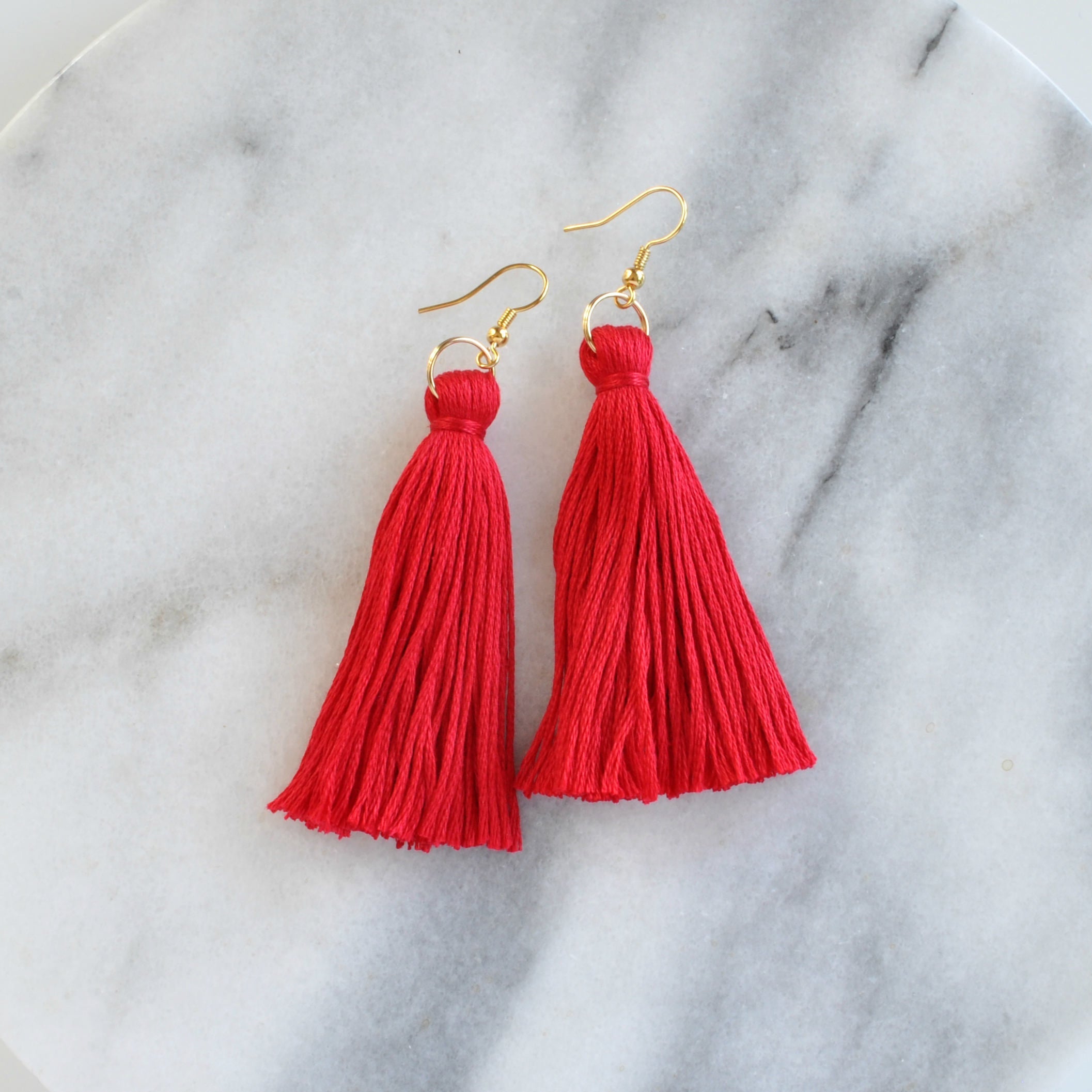 Libby & Smee red tassel earrings on gold earwires in long