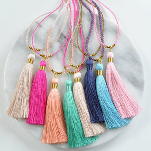 Libby & Smee champagne tassel necklace, with Libby & Smee beaded tassel necklaces in fuchsia, navy blue, aqua and pink