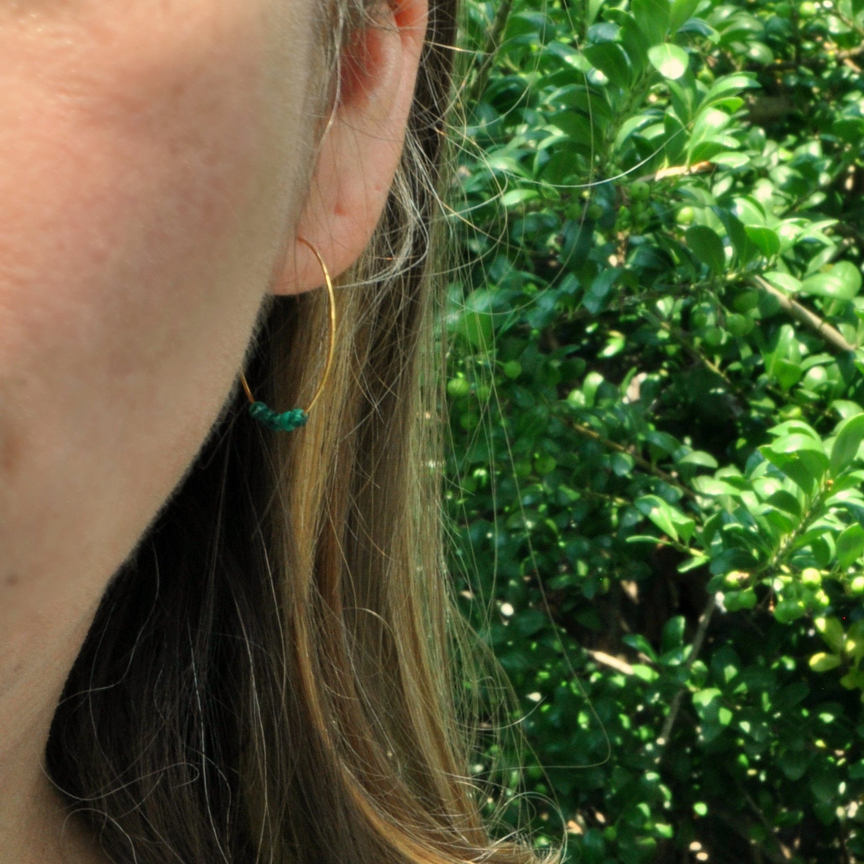 Libby & Smee Malachite Earrings on 25mm gold plated hoops on model