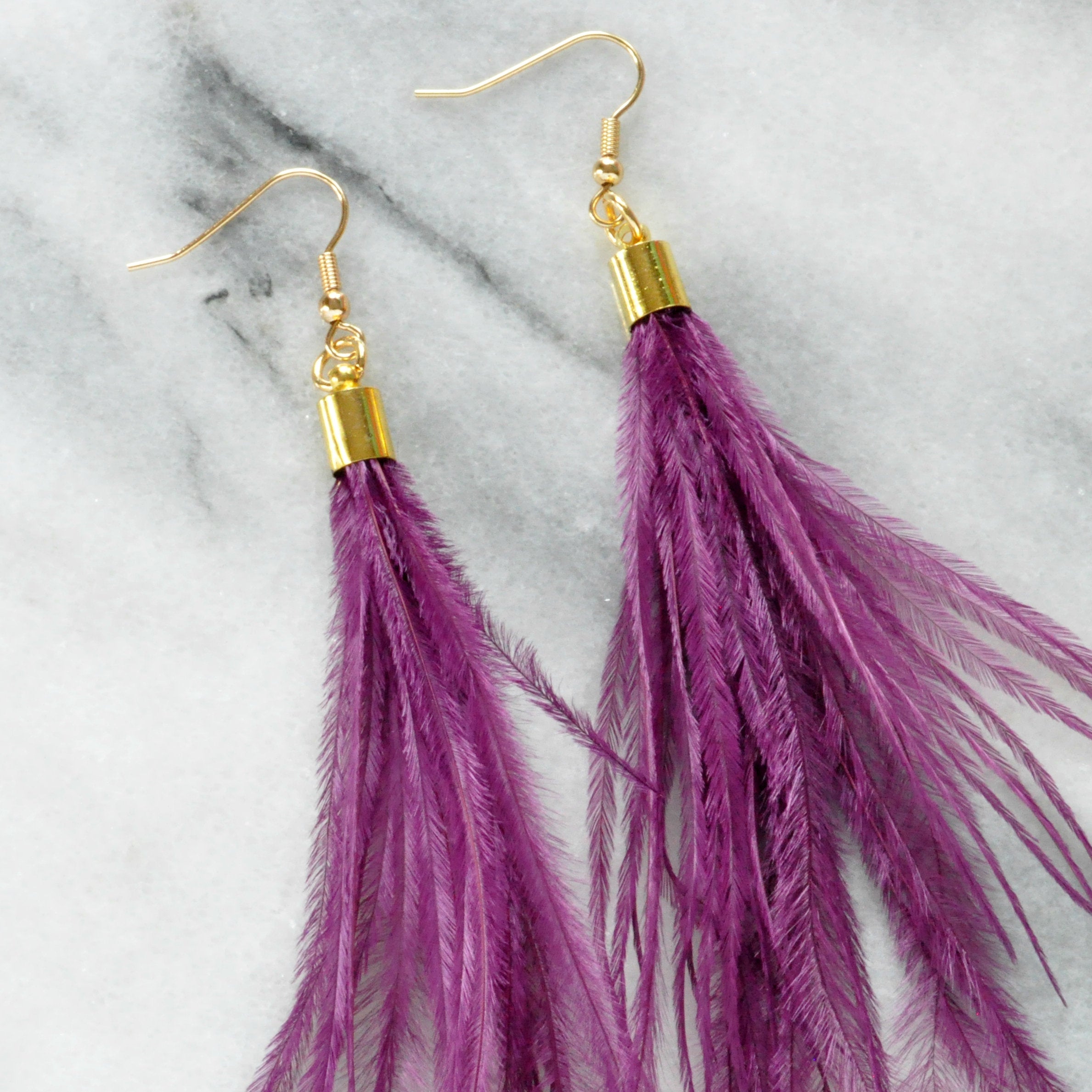 Libby & Smee Purple Feather Earrings with Ostrich feathers and gold caps, still life close up