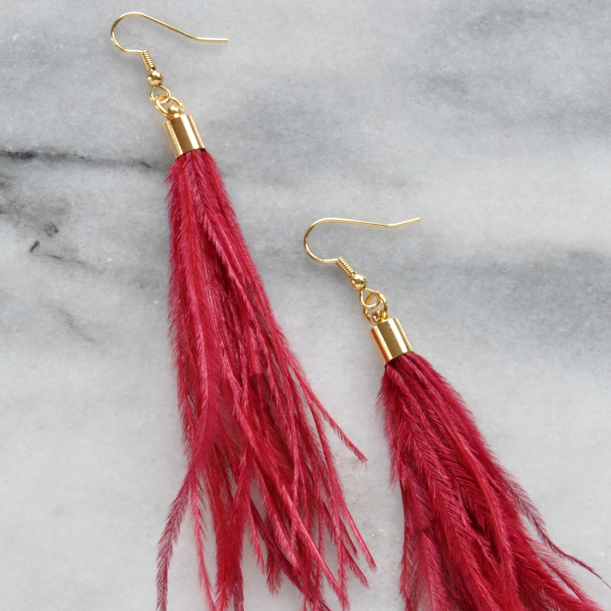 Libby & Smee Dark Red Feather Earrings with Ostrich Feathers and Gold Caps on Kraft Logo Earring Cards, still life close up