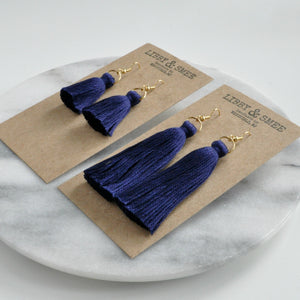 Libby & Smee Navy Tassel Earrings in Mini and Long on Kraft Earring Cards, Still life side angle