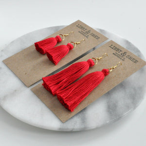 Libby & Smee red tassel earrings on gold earwires in mini or long on logo kraft earring cards, side angle