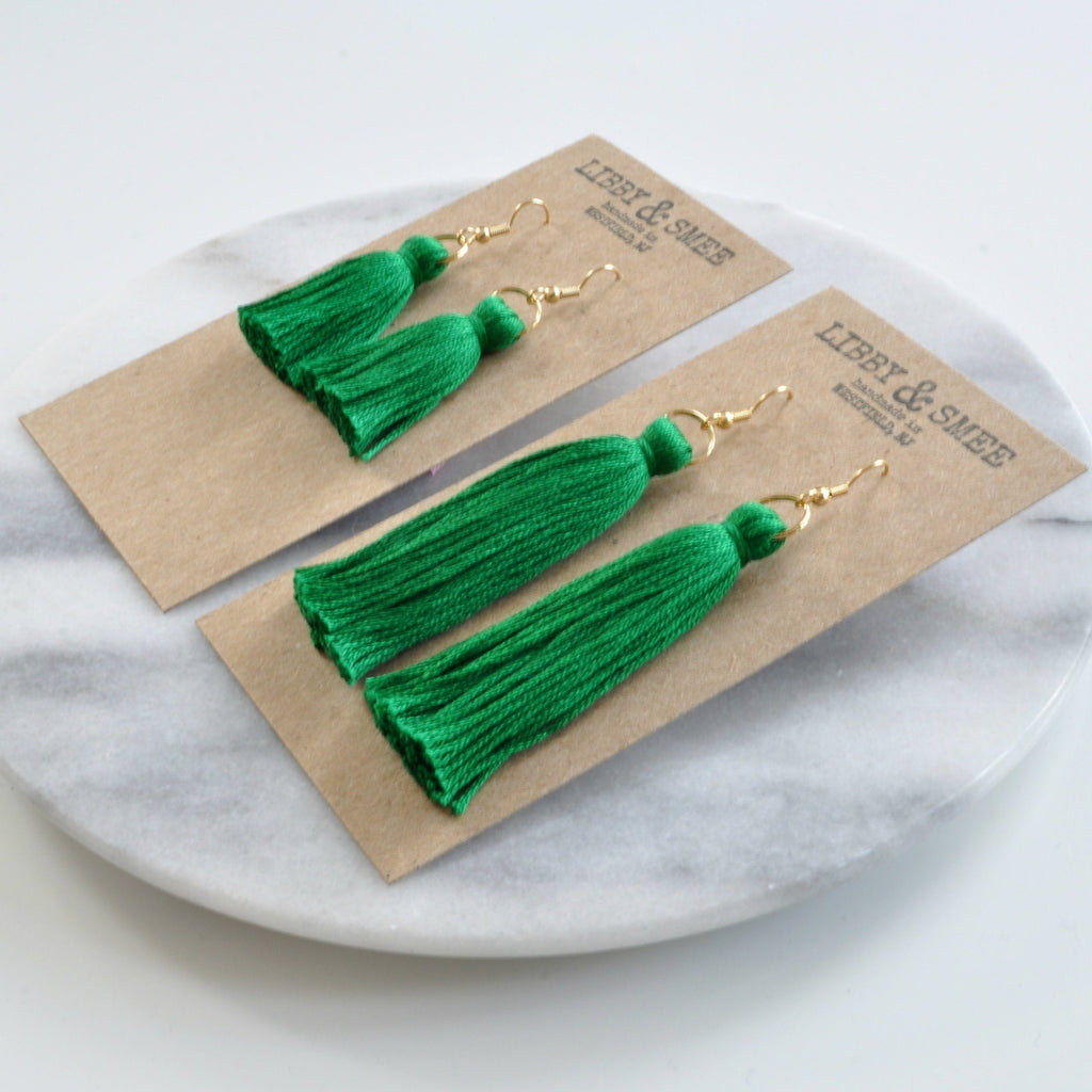 Emerald Green tassel earrings from Libby & Smee shown in mini and long sizes on logo-stamped kraft earring cards at an angle