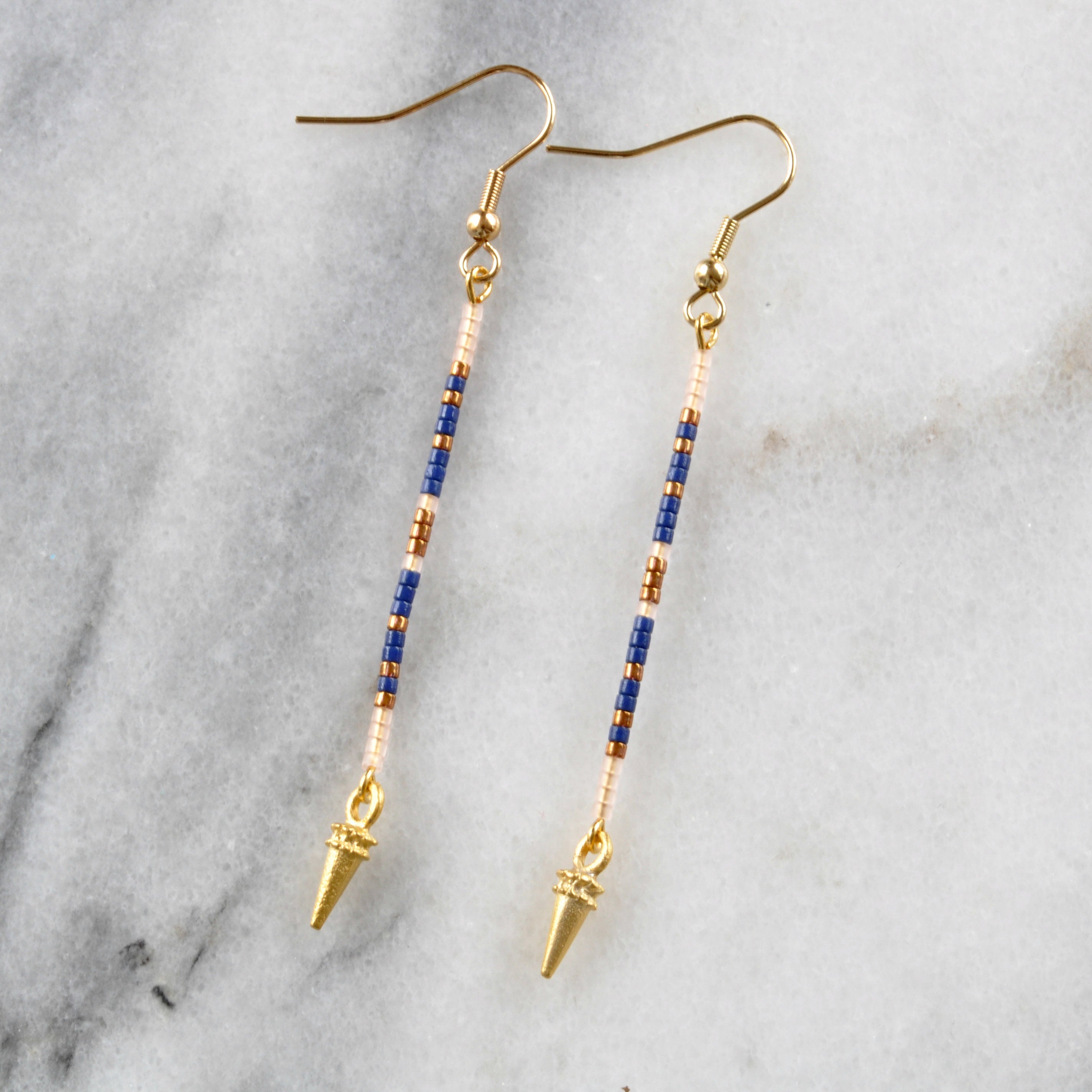 Long beaded earrings from Libby & Smee with a gold earwire and beaded pattern in Navy in navy, blush and bronze beads