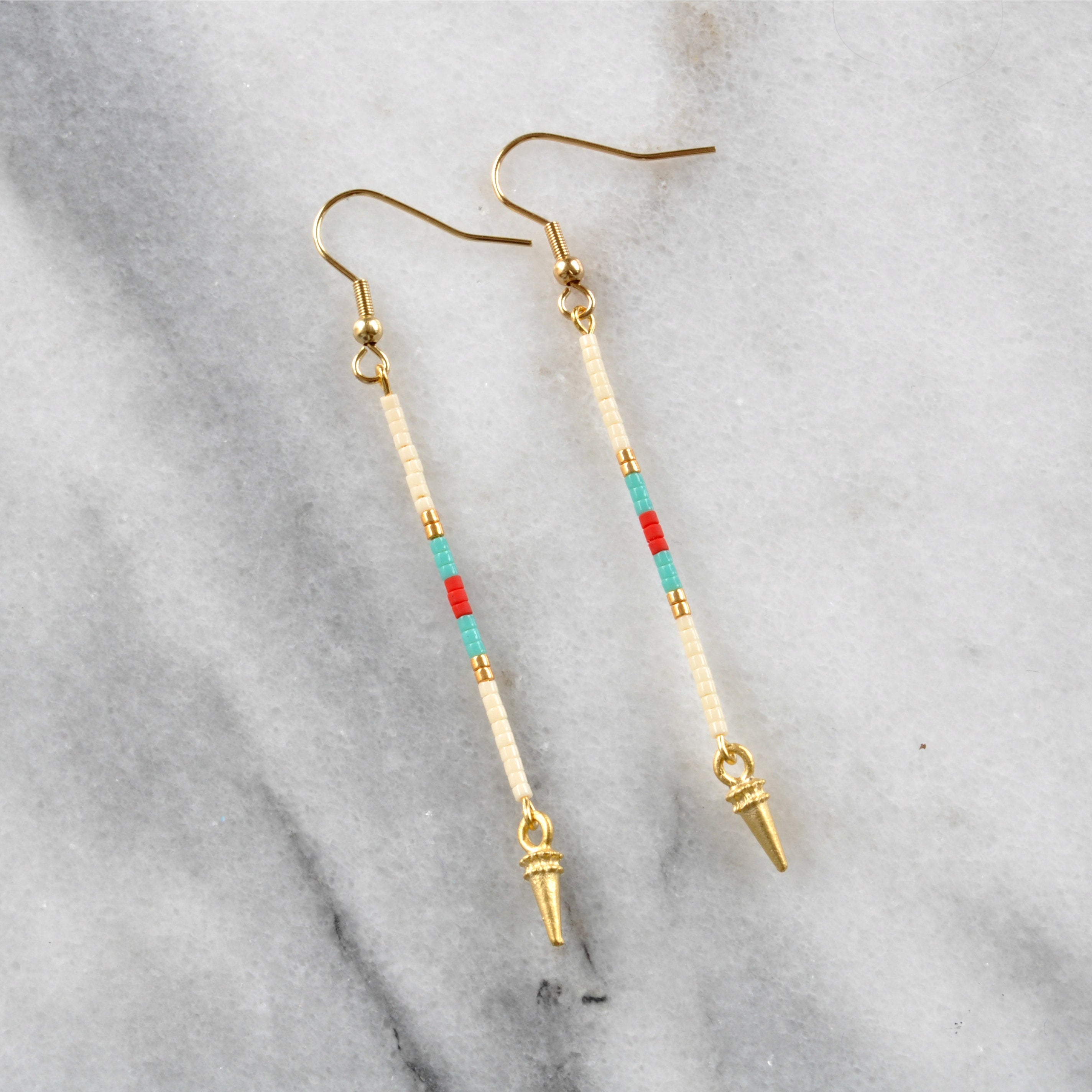 Long beaded earrings from Libby & Smee with a gold earwire and beaded pattern in Phoenix pattern with cream, turquoise, red and gold beads 