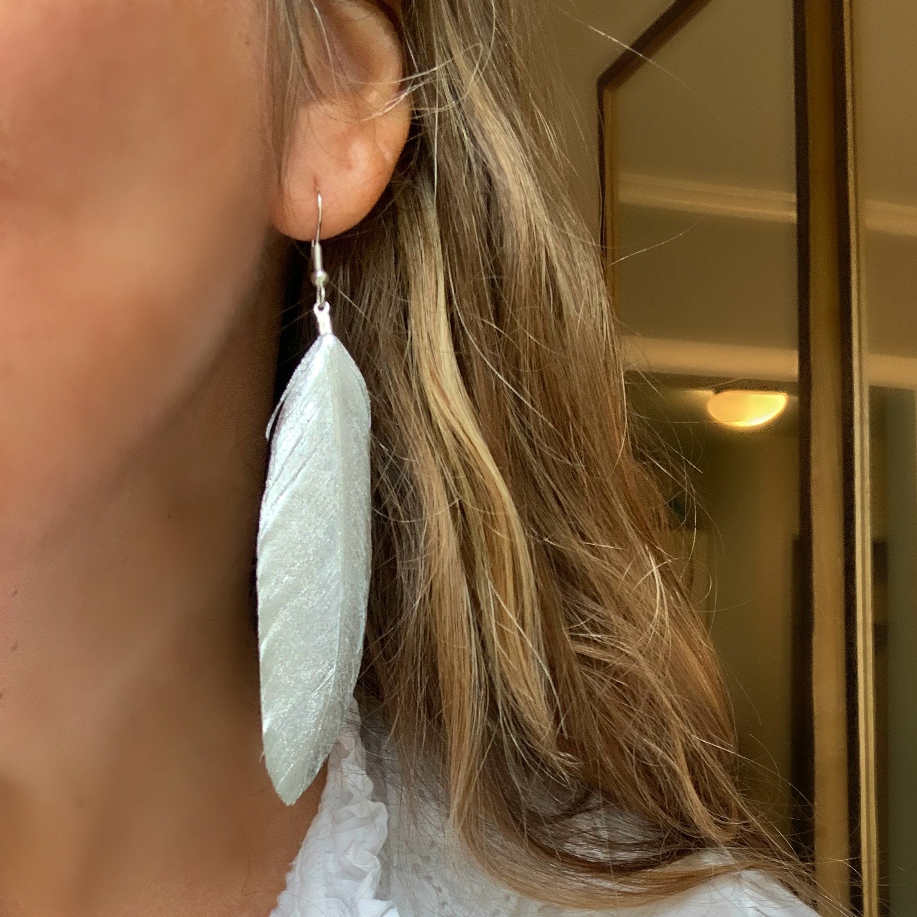 Libby & Smee Silver Feather Earrings on model