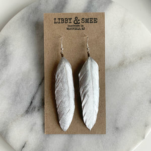 Libby & Smee Silver Feather Earrings on kraft earring card, still life