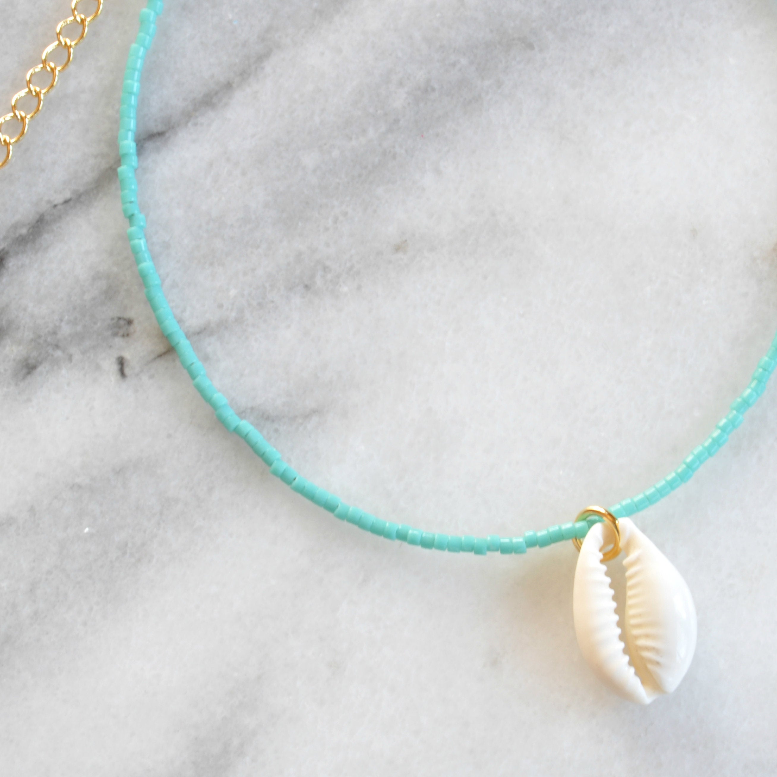 Libby & Smee Seashell Choker Necklace in turquoise with a cowrie seashell, Close up