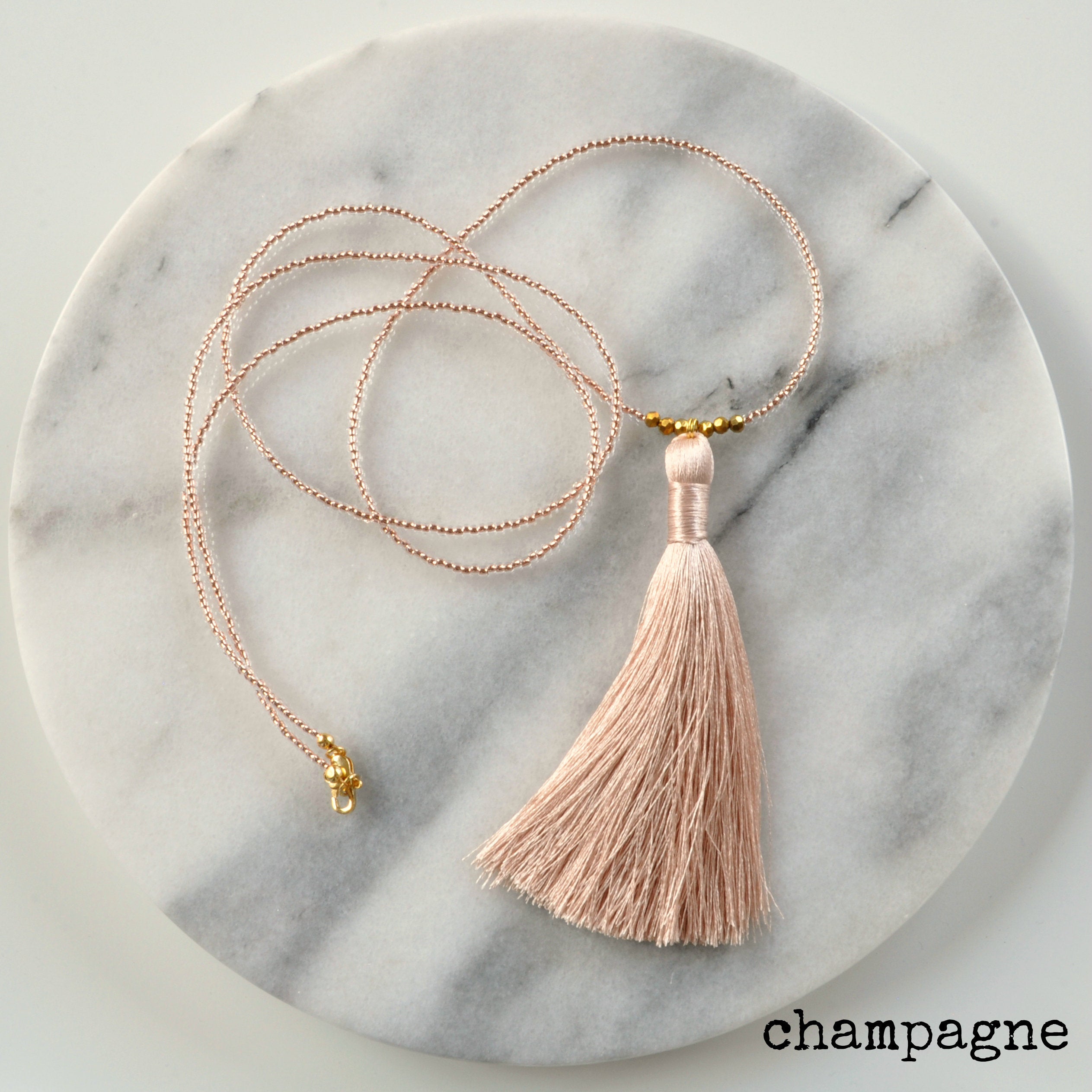 Libby & Smee Beaded Tassel Necklace in Champagne, still life labeled