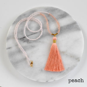 Libby & Smee Beaded Tassel Necklace in Peach, still life labeled