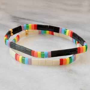 Libby & Smee Rainbow Stretch Bracelet in Ivory tile beads and in Black, still life