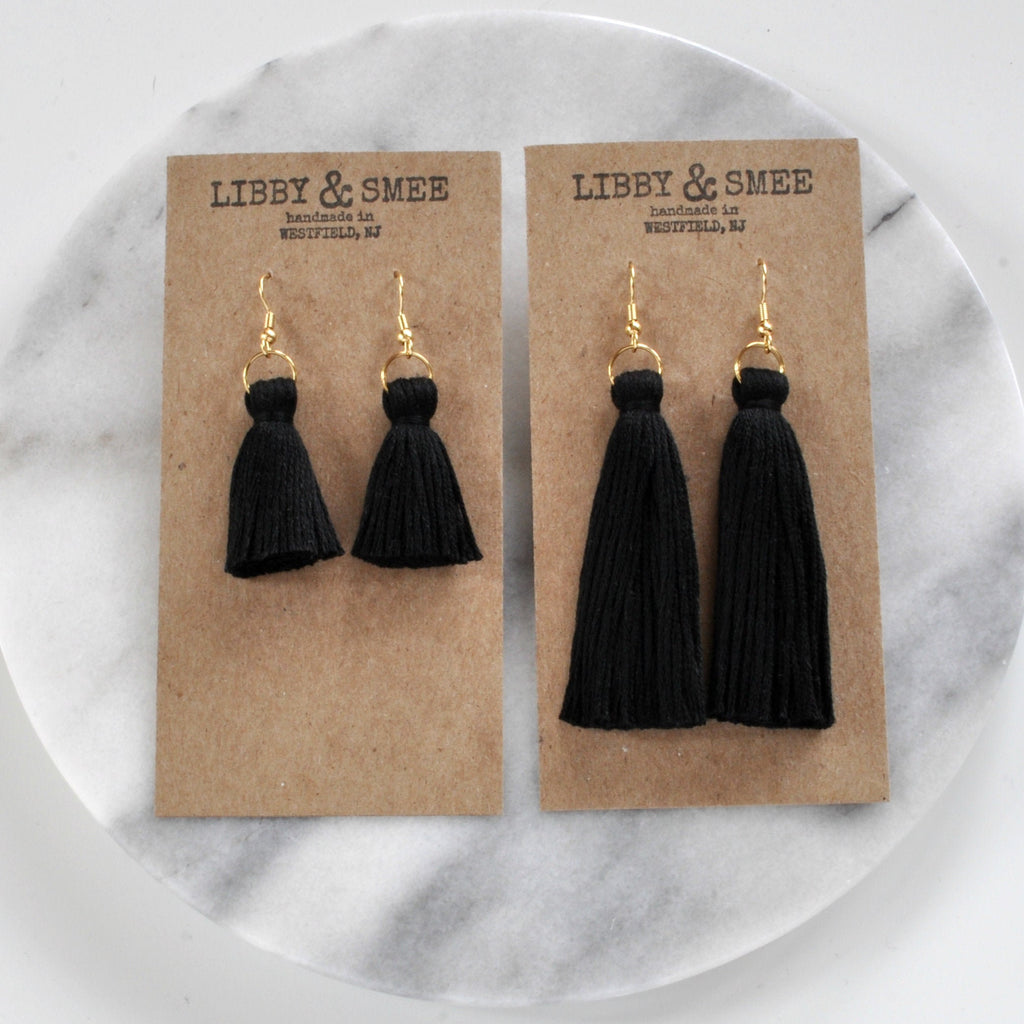 Libby & Smee black tassel earrings in mini and long, still life on kraft earring cards, overhead angle