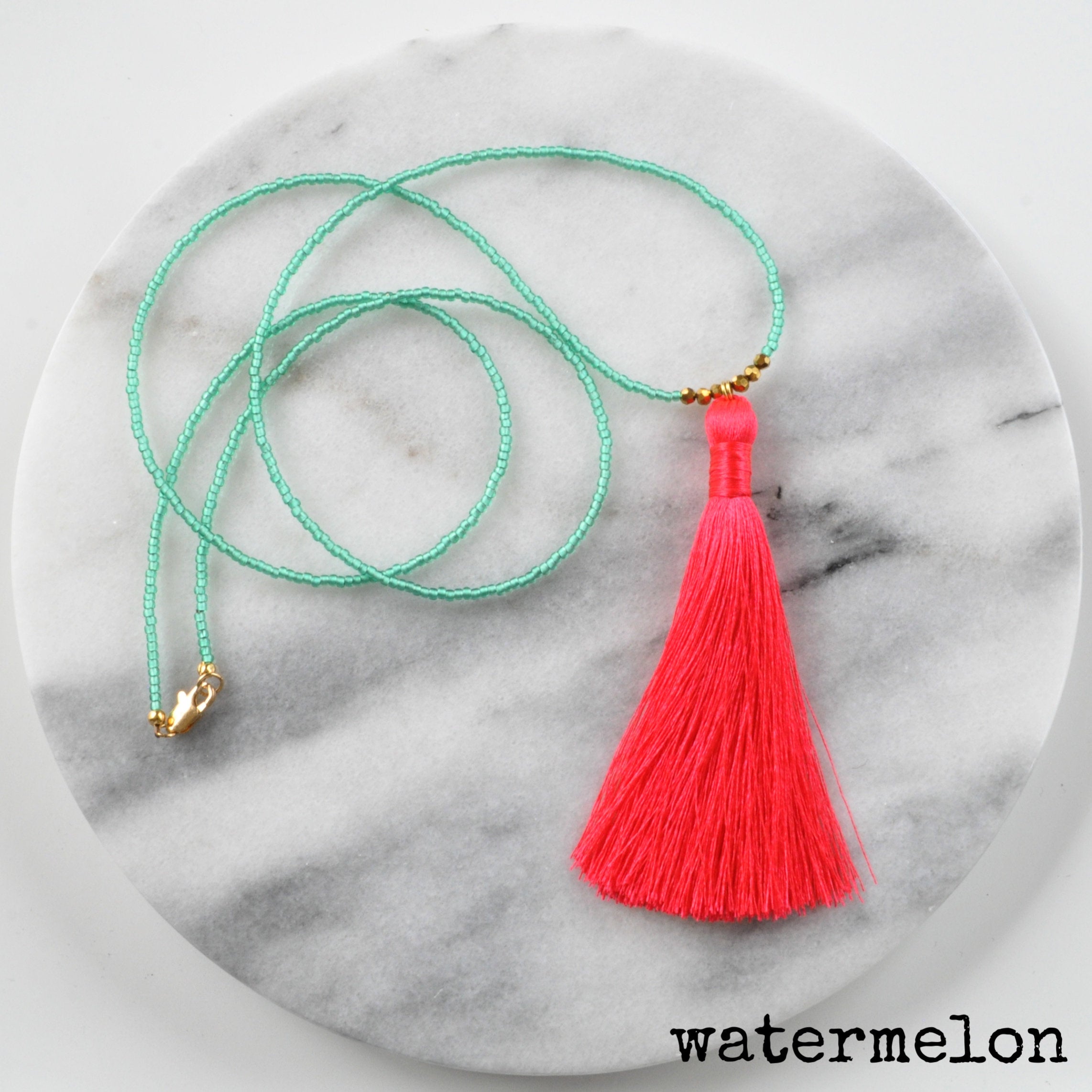 Libby & Smee Beaded Tassel Necklace in coral and green, still life labeled Watermelon