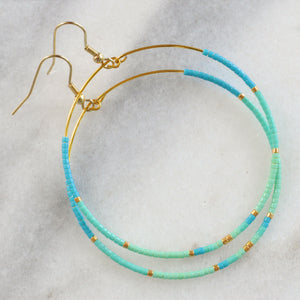 Libby & Smee Big Beaded Hoops in "Aruba" style with gold-plated ear wire and small seed beads in turquoise, aqua, mint and gold in size "bigger" circle shape   - still life