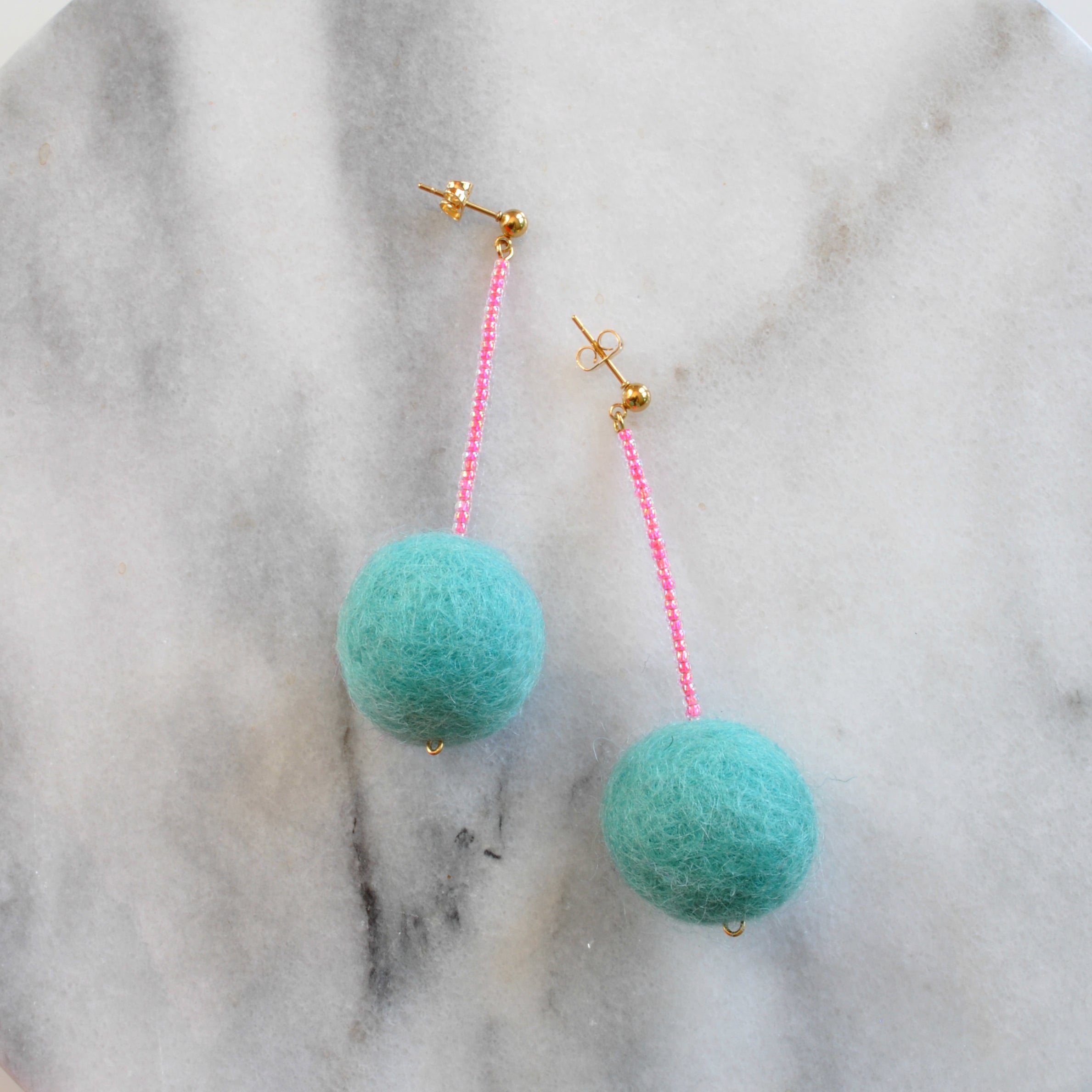Libby & Smee pom pom earrings in Aqua with Neon Pink color  combination 